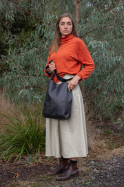 Model wears Ripple and Co Leather Cross Shoulder Jude Bag Black