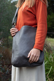 Model wears Ripple and Co Jude Leather Cross Shoulder Bag Elephant Grey